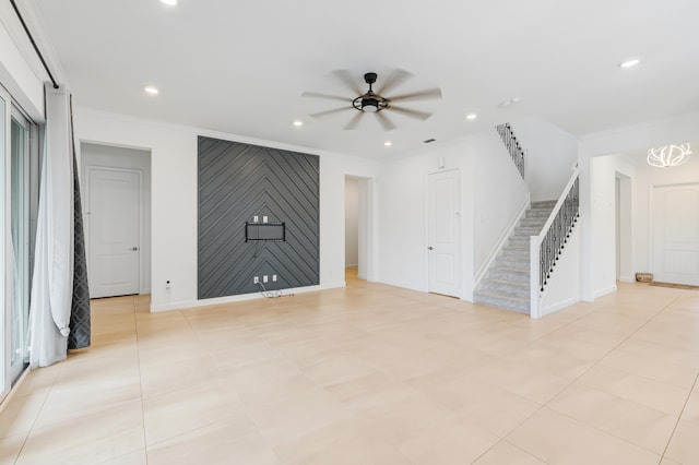 unfurnished living room with ceiling fan and crown molding