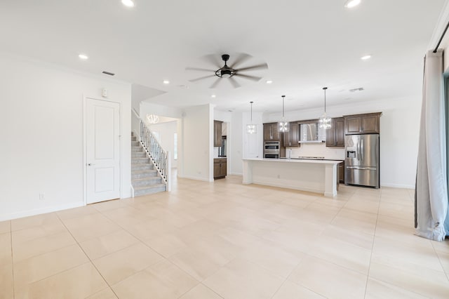 unfurnished living room with ceiling fan, light tile patterned floors, and crown molding