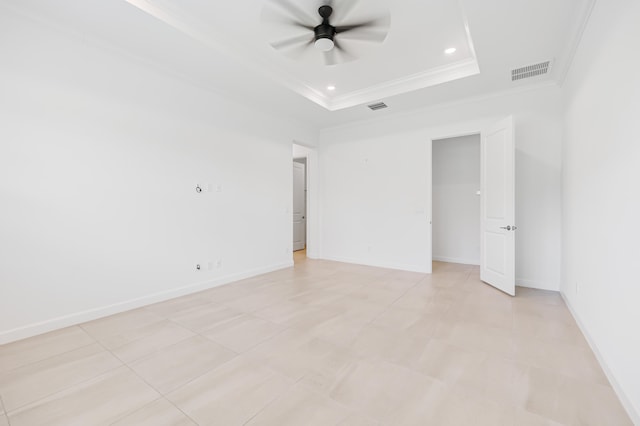 spare room featuring ornamental molding, a tray ceiling, and ceiling fan