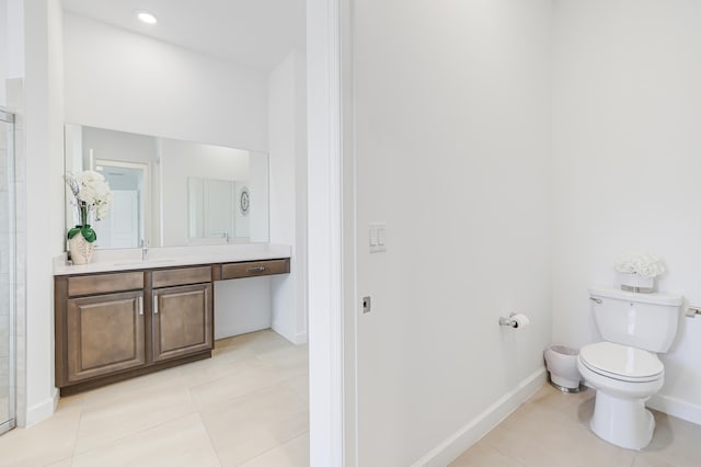 bathroom with vanity, tile patterned flooring, and toilet