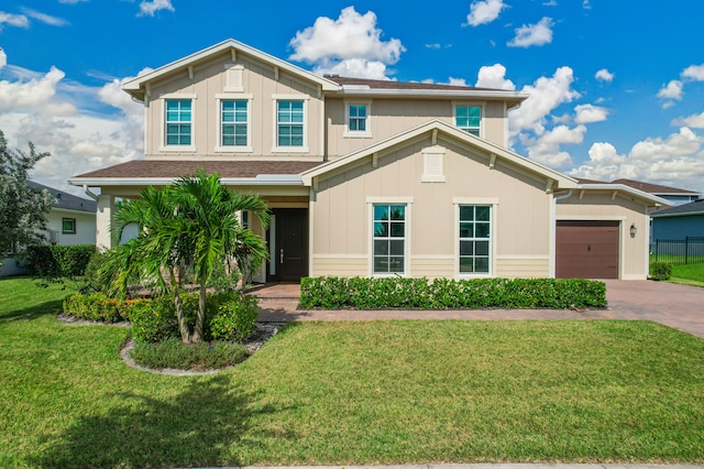 view of front facade featuring a front yard and a garage