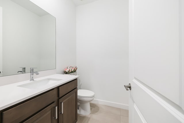 bathroom featuring vanity, toilet, and tile patterned floors