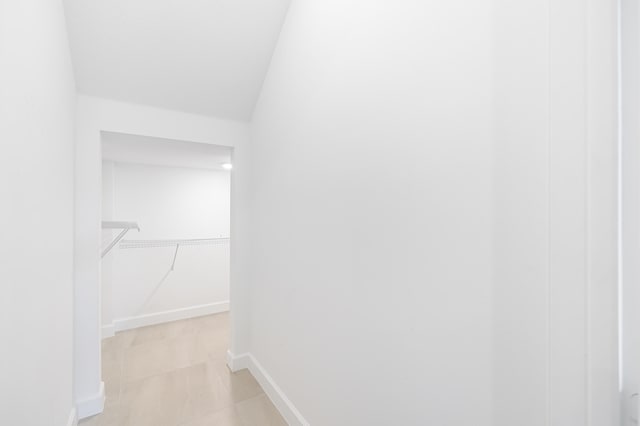 interior space with lofted ceiling and light tile patterned floors