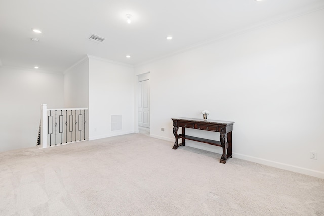 carpeted spare room featuring ornamental molding