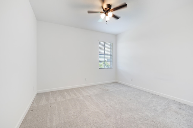 empty room with ceiling fan and light colored carpet