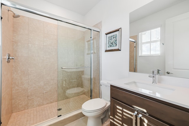 bathroom with tile patterned flooring, vanity, toilet, and a shower with shower door