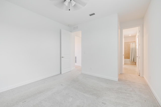 carpeted spare room with ceiling fan