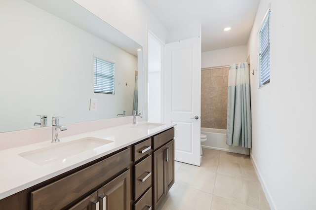 full bathroom featuring vanity, shower / bath combo with shower curtain, toilet, and tile patterned flooring