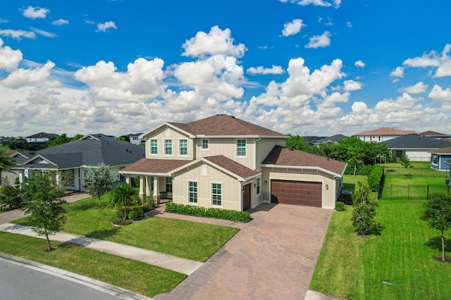 view of front of house featuring a front lawn and a garage