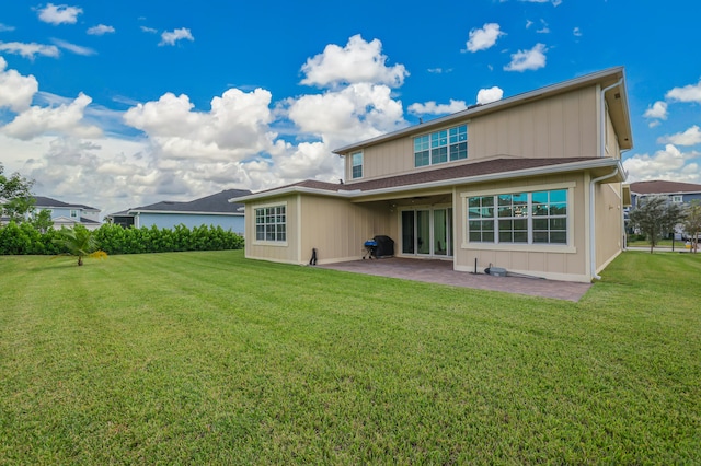 rear view of property with a patio and a yard