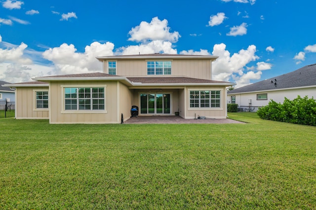 rear view of house with a yard and a patio area