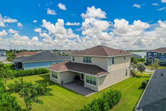 rear view of property with a lawn and a patio area