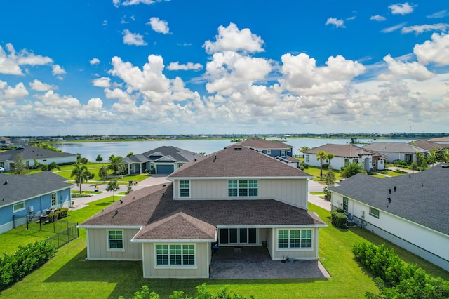 birds eye view of property with a water view