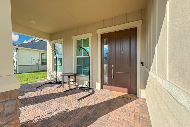 property entrance featuring a patio area