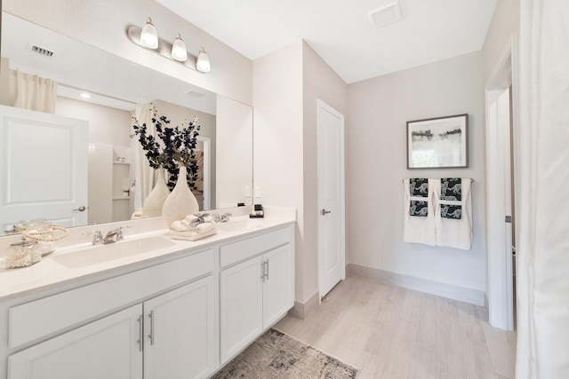 bathroom featuring hardwood / wood-style floors and vanity