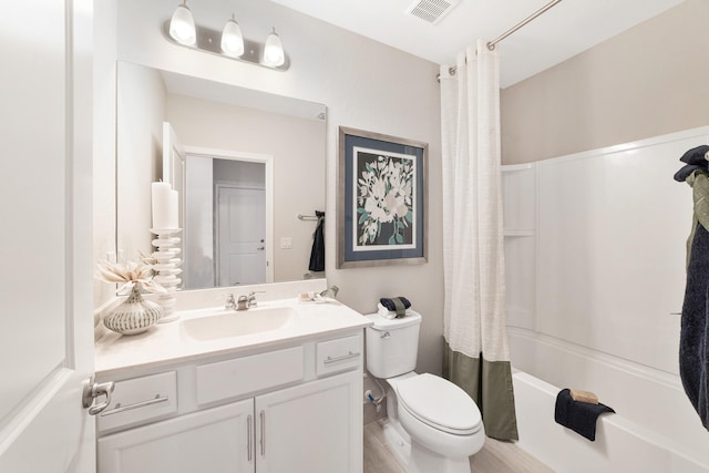 full bathroom with vanity, toilet, shower / bathtub combination with curtain, and hardwood / wood-style flooring