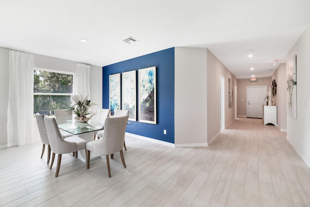 dining space with light hardwood / wood-style flooring