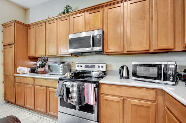 kitchen with appliances with stainless steel finishes and light tile patterned floors