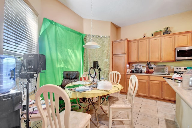 kitchen with light tile patterned flooring and pendant lighting