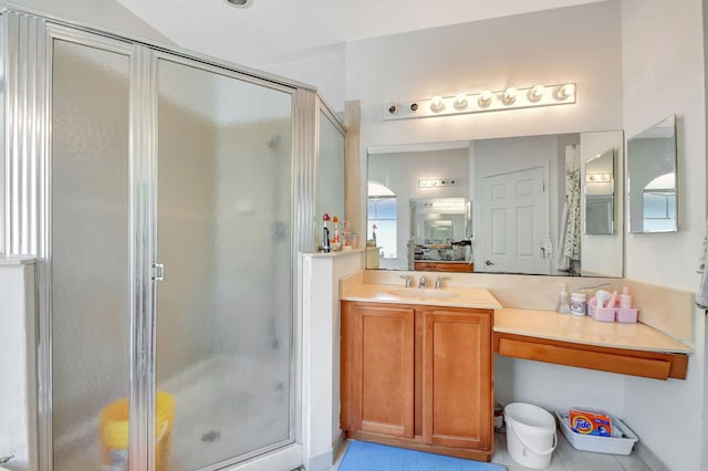 bathroom featuring tile patterned flooring, vanity, and a shower with shower door