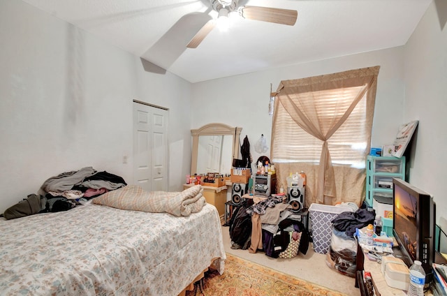 carpeted bedroom with a closet and ceiling fan