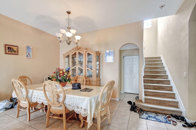 dining area with a notable chandelier and light tile patterned floors