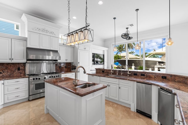 kitchen featuring appliances with stainless steel finishes, sink, hanging light fixtures, white cabinets, and a center island with sink