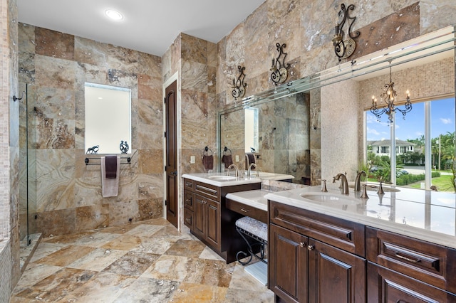 bathroom featuring vanity, tile walls, a chandelier, and an enclosed shower