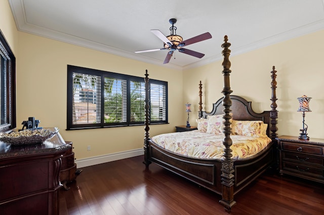 bedroom with ornamental molding, dark wood-type flooring, and ceiling fan