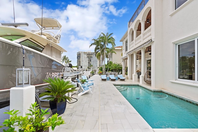 view of swimming pool with a patio