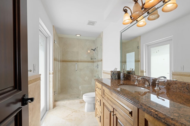 bathroom featuring toilet, walk in shower, vanity, and tile patterned flooring