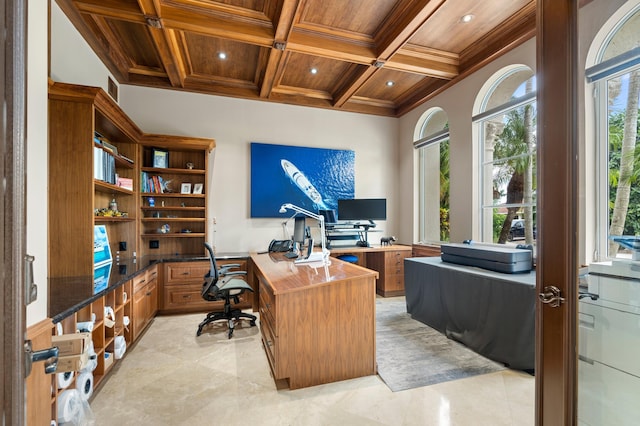 office area with wood ceiling, beam ceiling, built in desk, ornamental molding, and coffered ceiling