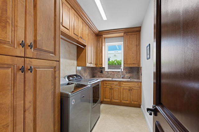 washroom featuring cabinets, independent washer and dryer, and sink