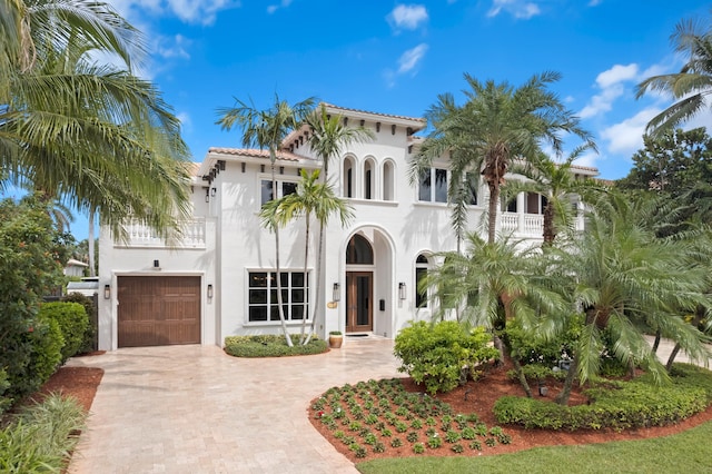 mediterranean / spanish house featuring a garage