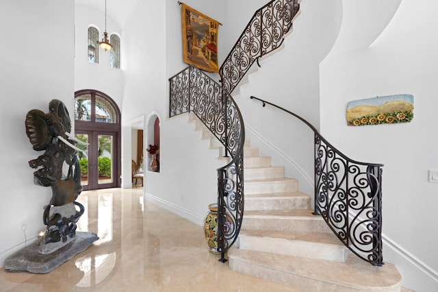 foyer with french doors and a towering ceiling