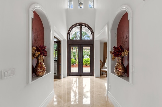 foyer featuring french doors and a high ceiling