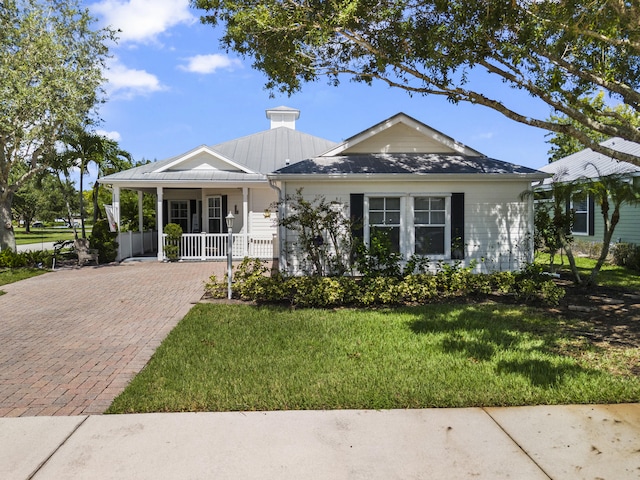 ranch-style house with a front lawn and covered porch