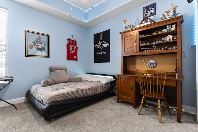 bedroom featuring light colored carpet and multiple windows