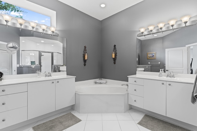 bathroom with tile patterned floors, vanity, and separate shower and tub