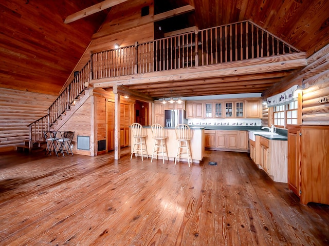 kitchen with high vaulted ceiling, light hardwood / wood-style flooring, wooden ceiling, and stainless steel refrigerator with ice dispenser