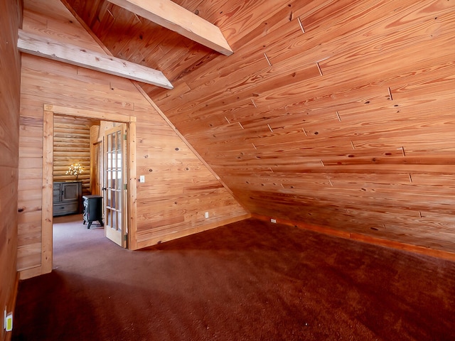 bonus room featuring dark carpet, vaulted ceiling with beams, wooden walls, and wood ceiling