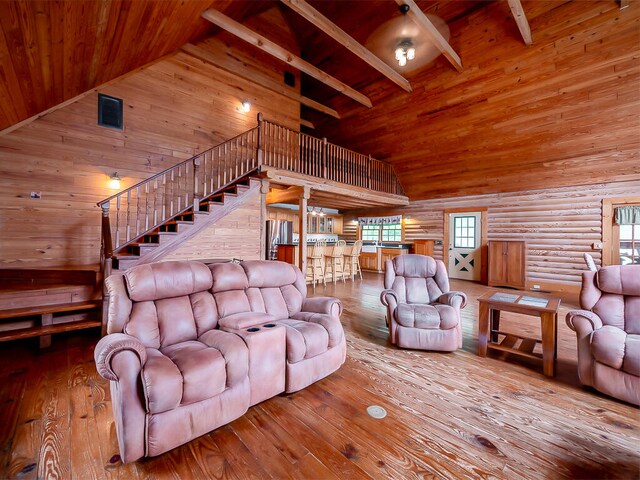 living room with wood ceiling, beam ceiling, hardwood / wood-style floors, and high vaulted ceiling