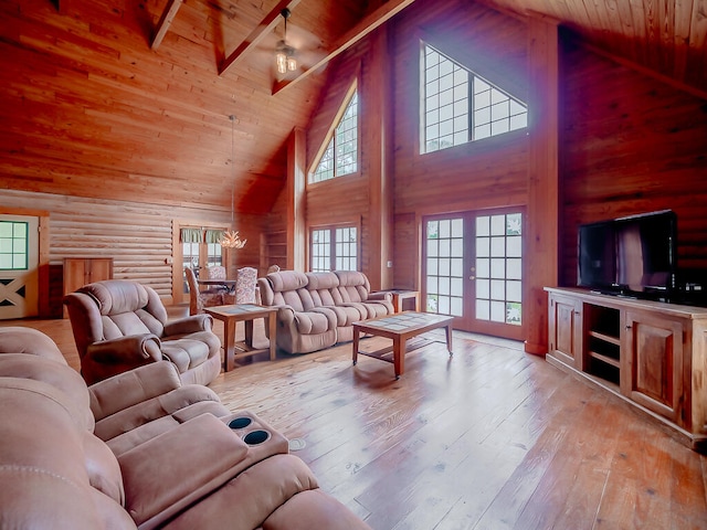 living room with light wood-type flooring, wooden ceiling, beam ceiling, french doors, and high vaulted ceiling