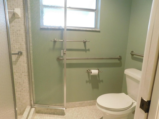 bathroom with tile patterned flooring, toilet, and an enclosed shower