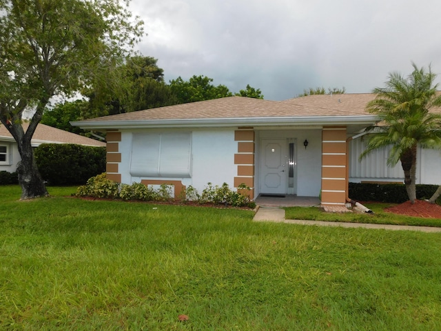 ranch-style house with a front lawn