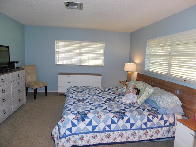 carpeted bedroom with a textured ceiling