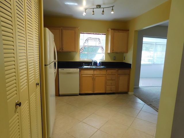 kitchen with sink, light tile patterned floors, and white appliances