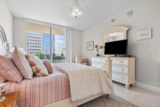 tiled bedroom featuring an inviting chandelier, a textured ceiling, and access to outside