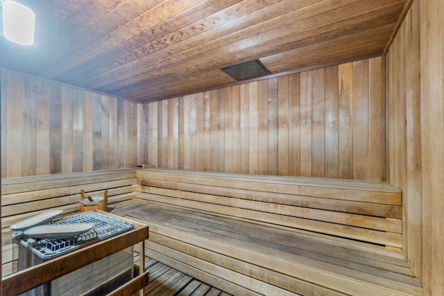 view of sauna / steam room featuring wood walls, hardwood / wood-style flooring, and wooden ceiling