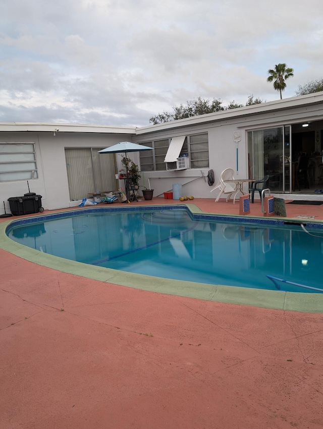 view of swimming pool featuring a patio area